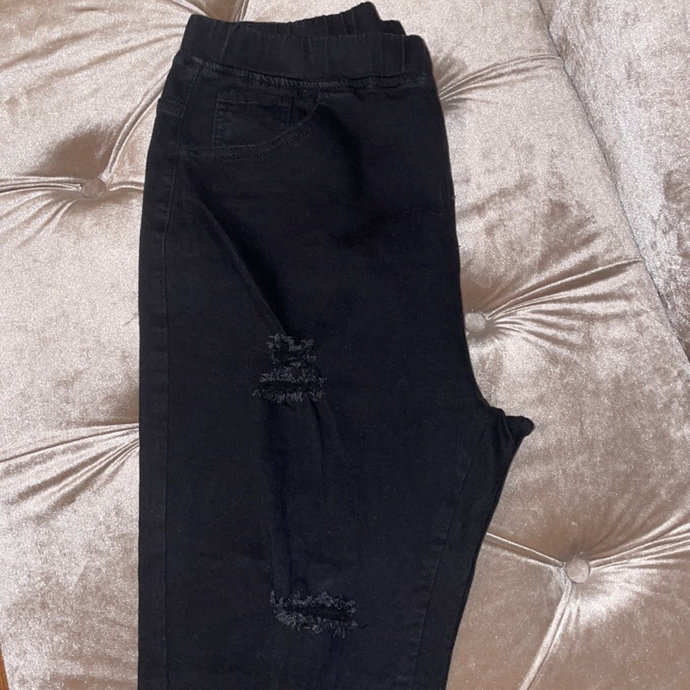 Black ripped jeans with elastic band waist.